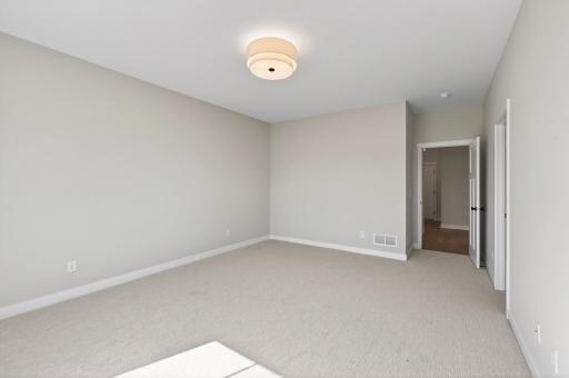 Primary bedroom with private ensuite and walk-in closet