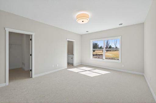 Primary bedroom with private ensuite and walk-in closet