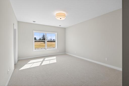 Primary bedroom with private ensuite and walk-in closet
