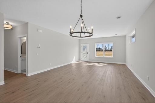 Dining and living room areas with access to rear patio space