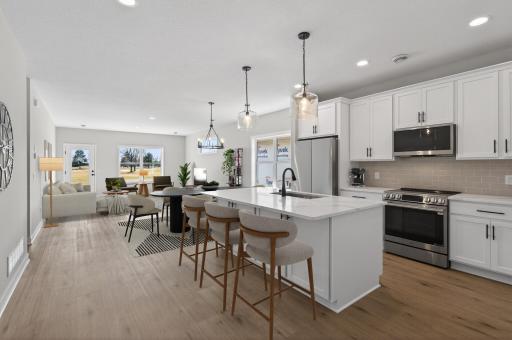 View of kitchen, dining room, and living room spaces. *Virtually staged