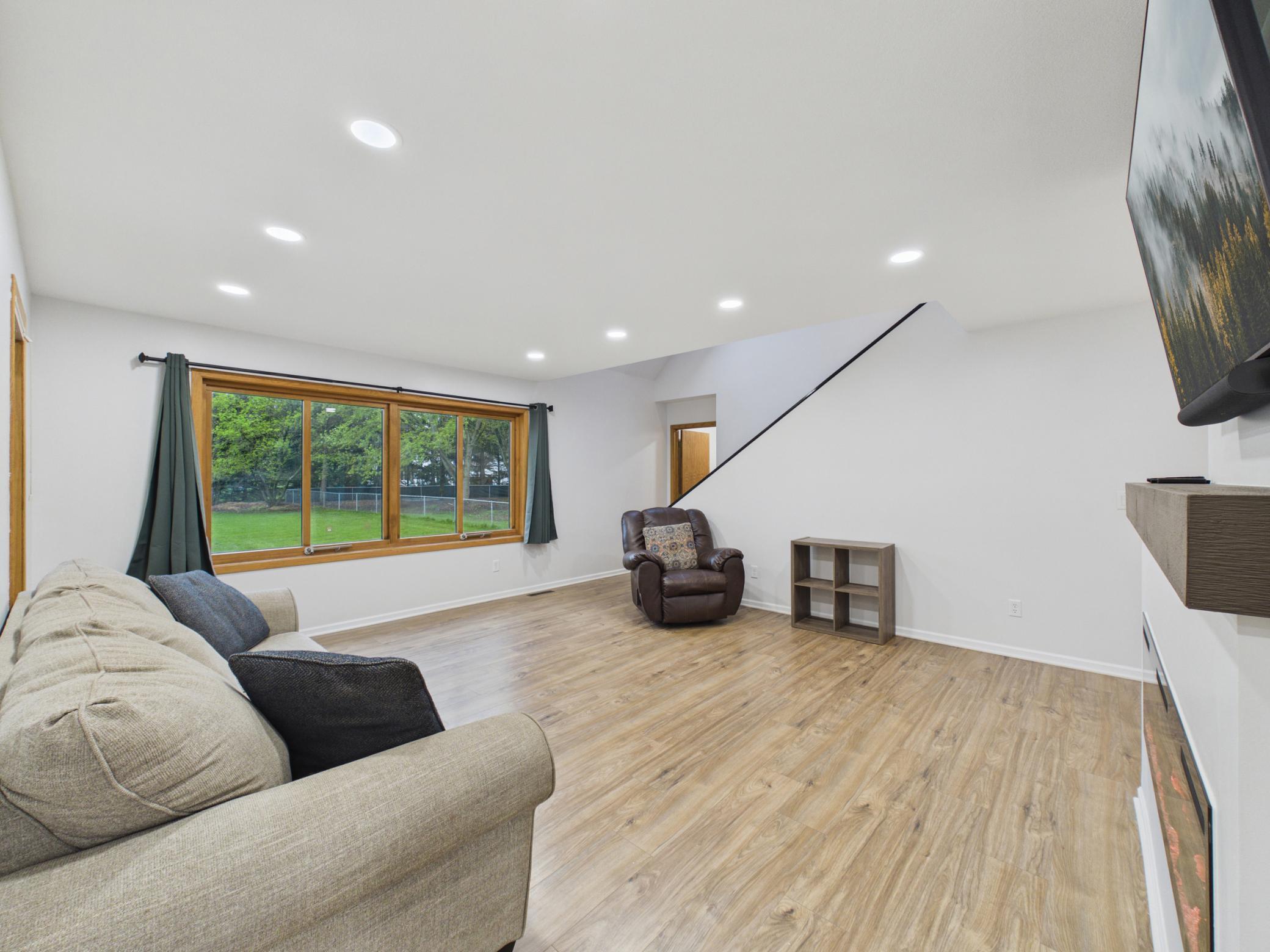 You will enter into a spacious living room with newer recessed lighting and flooring.