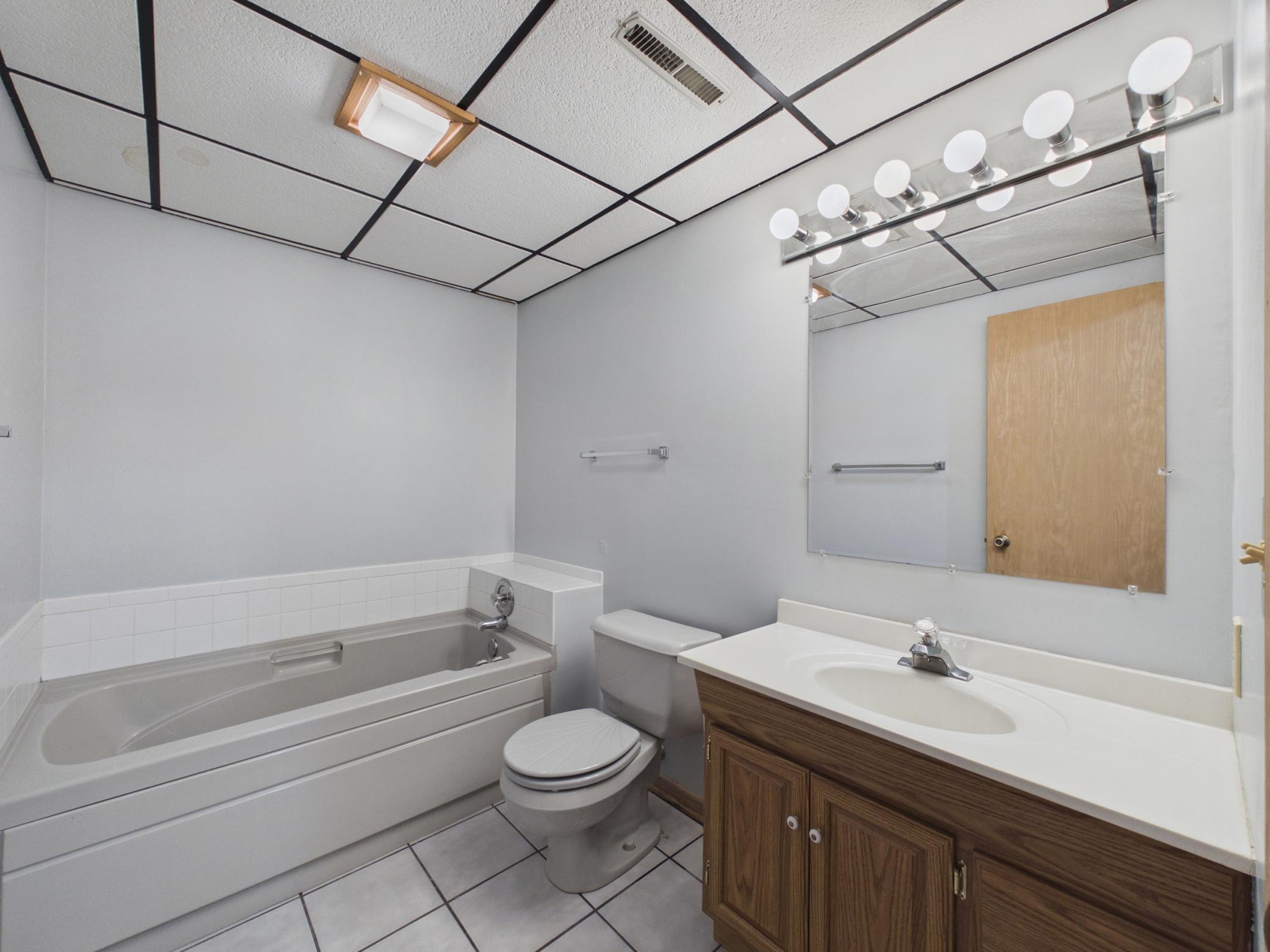 Lower level bathroom with a tub for escaping.