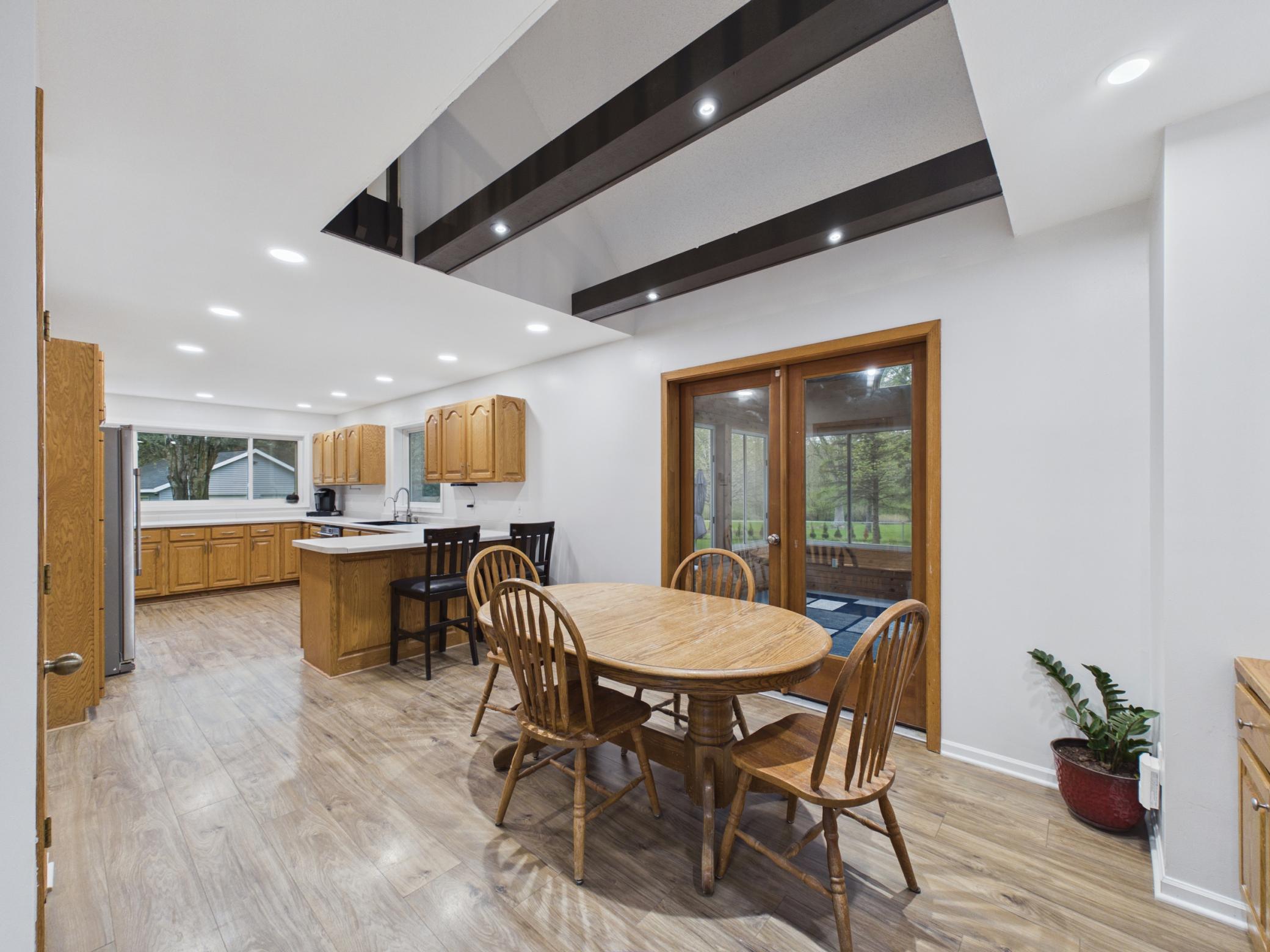 Dining room with fun beams in the loft area and a spacious kitchen.