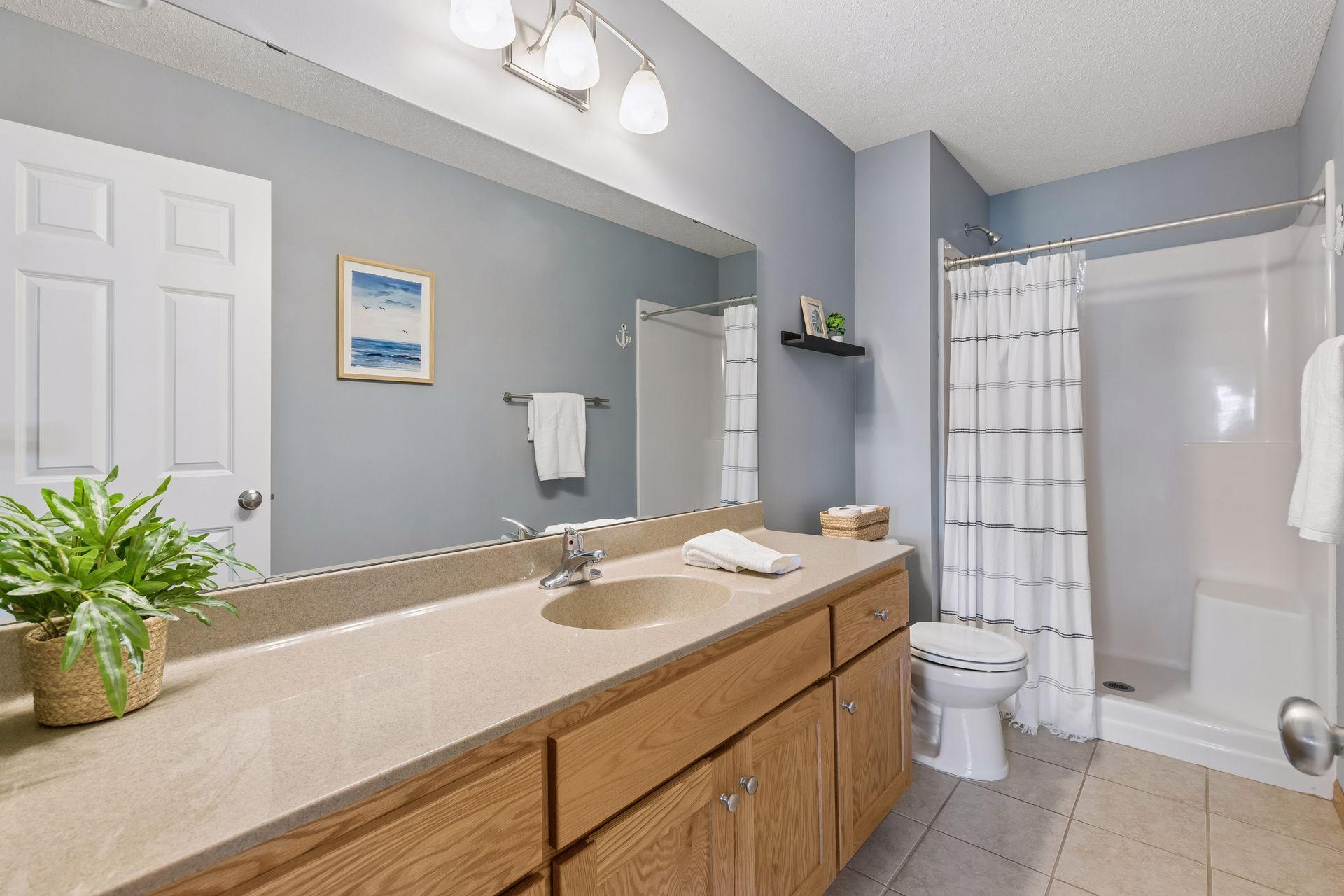 Another bath on the lower level is spacious, and like all the other baths in this home, is meticulously maintained.
