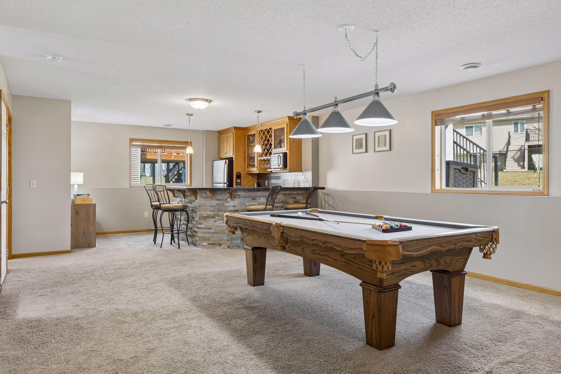 Huge lower level family room has a stunning wet bar complete with full size fridge. Garden windows make this level bright and welcoming.