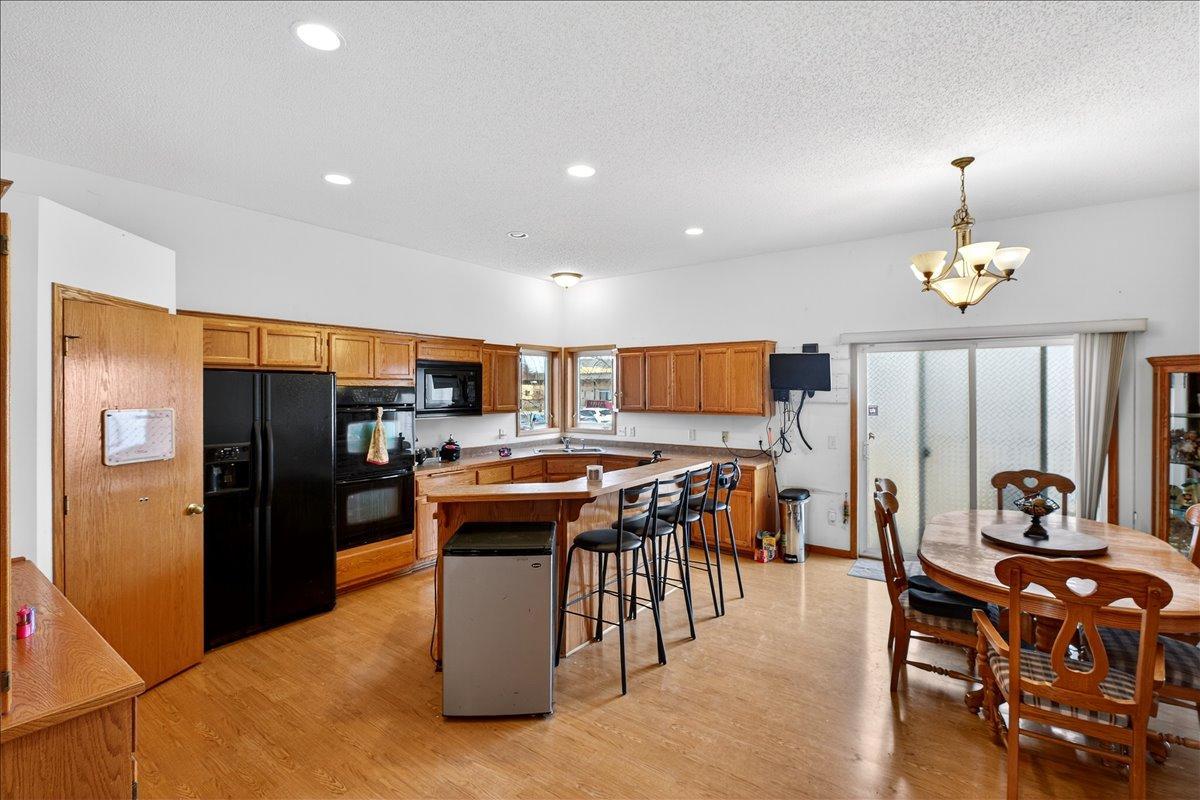 Large open kitchen and dining area with walk-out to the deck