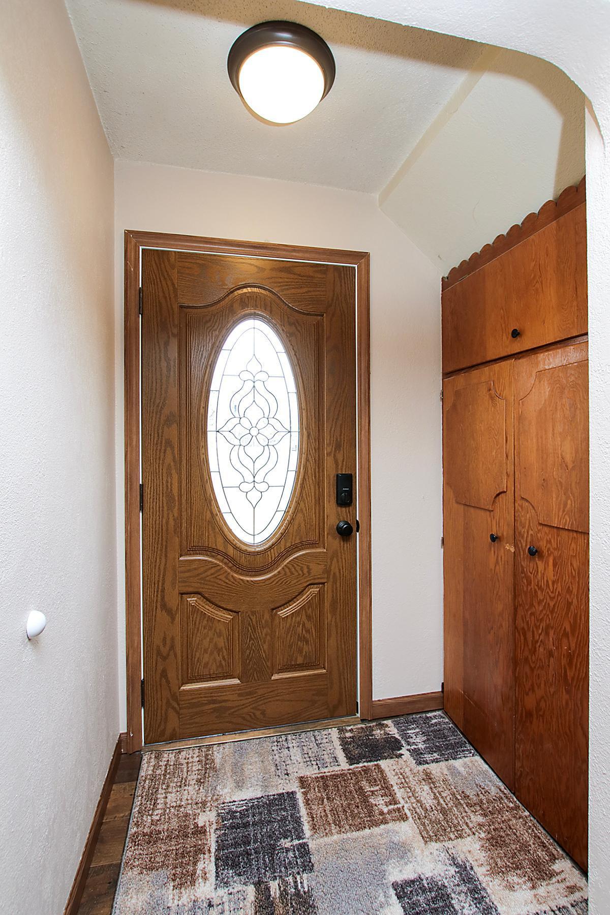 Attractive Front Entry door and lots of built-ins on the right to hang coats!