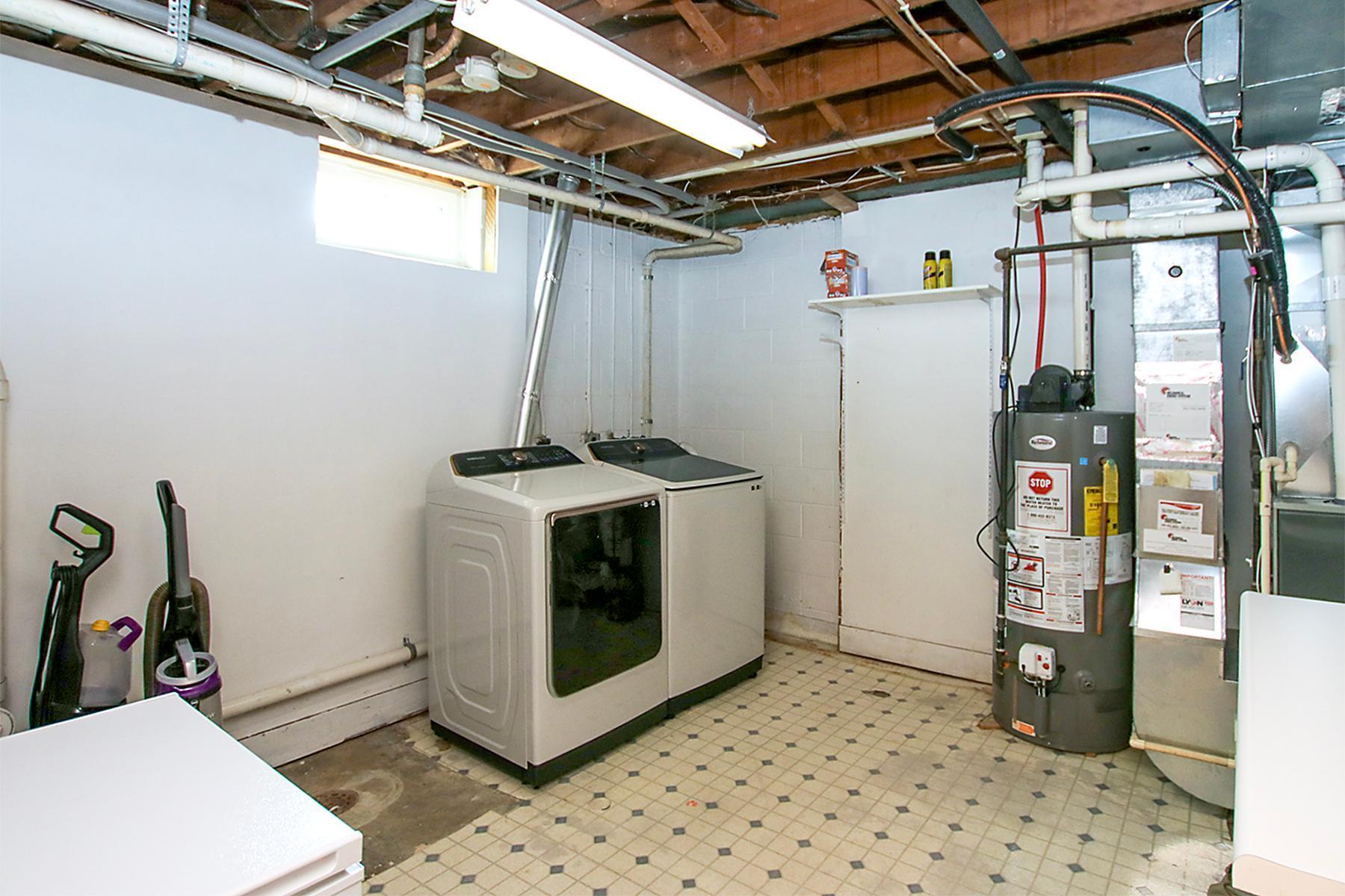 Clean and Crisp laundry and mechanical area featuring a newer furnace!