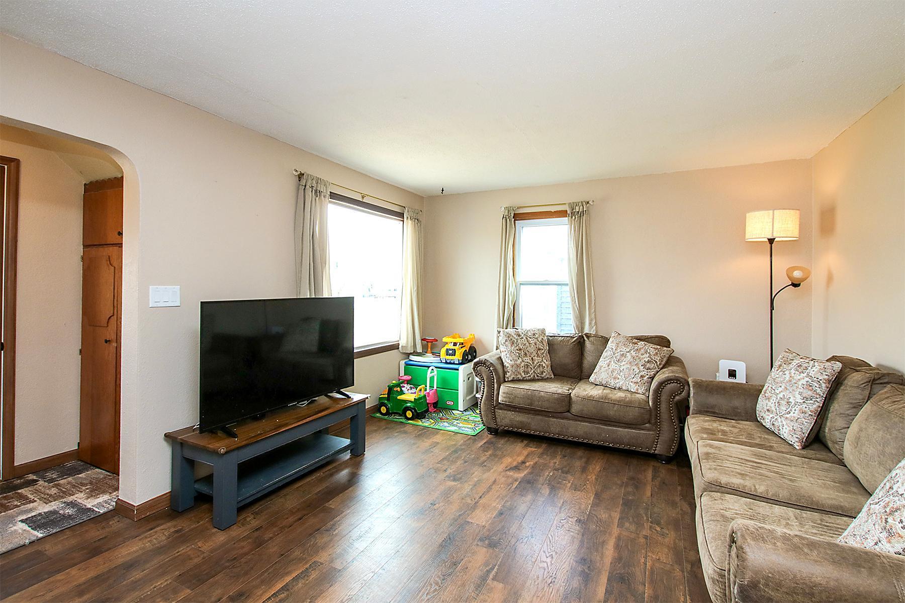 Living room with updated flooring is large and inviting!