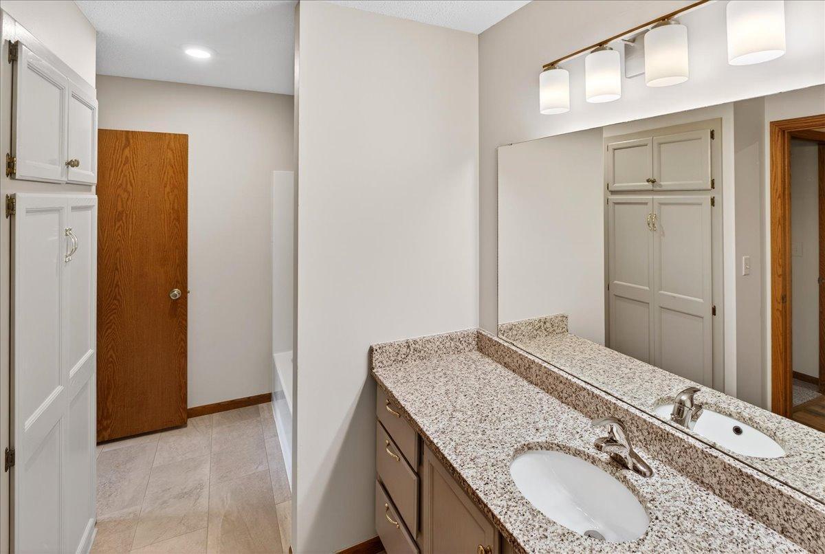 Primary Bedroom walk-thru Full Bath; Granite Vanity with new fixture, updated light fixture