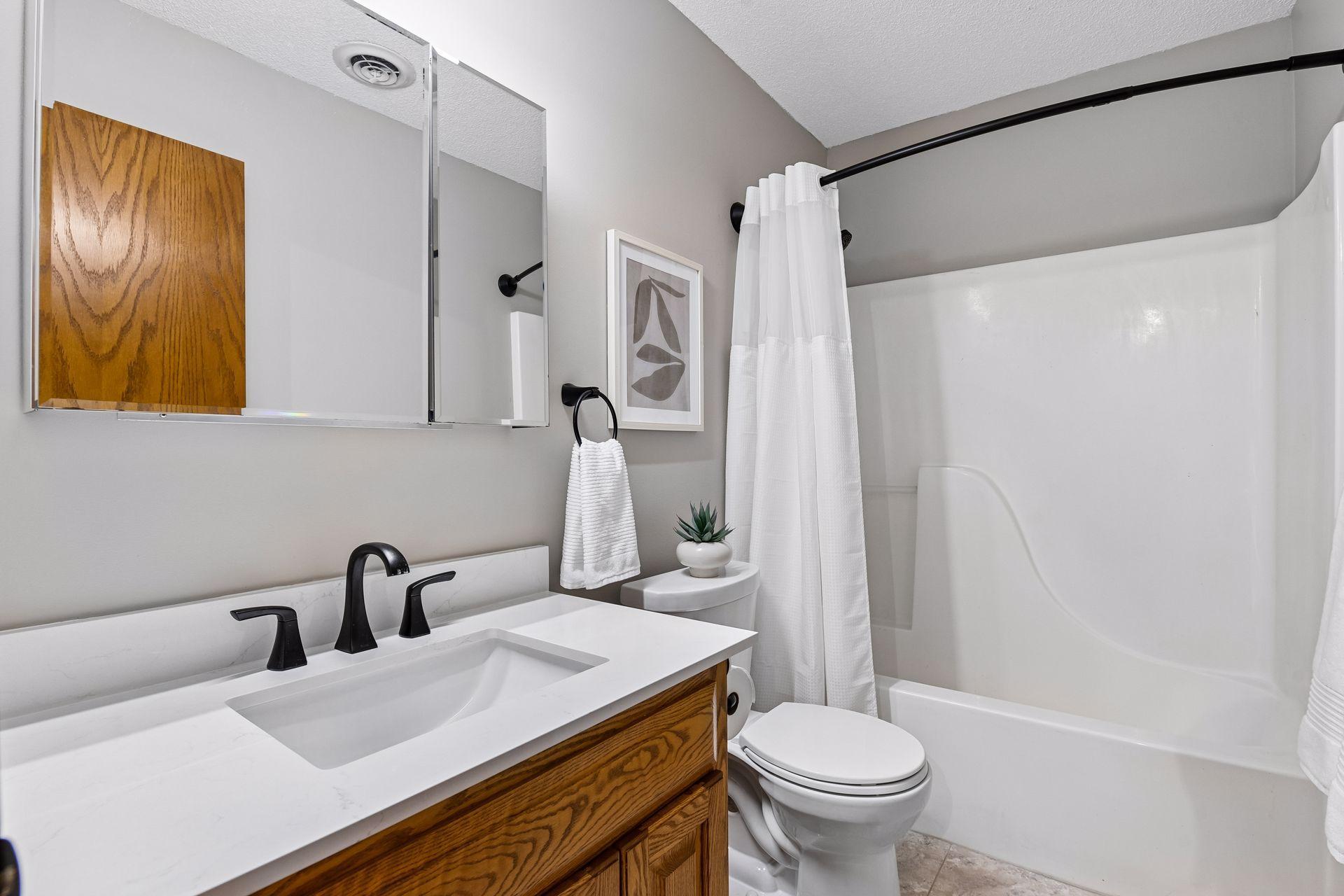 Full bath on 2nd level with ceramic tile flooring for beds 2 & 3 to share