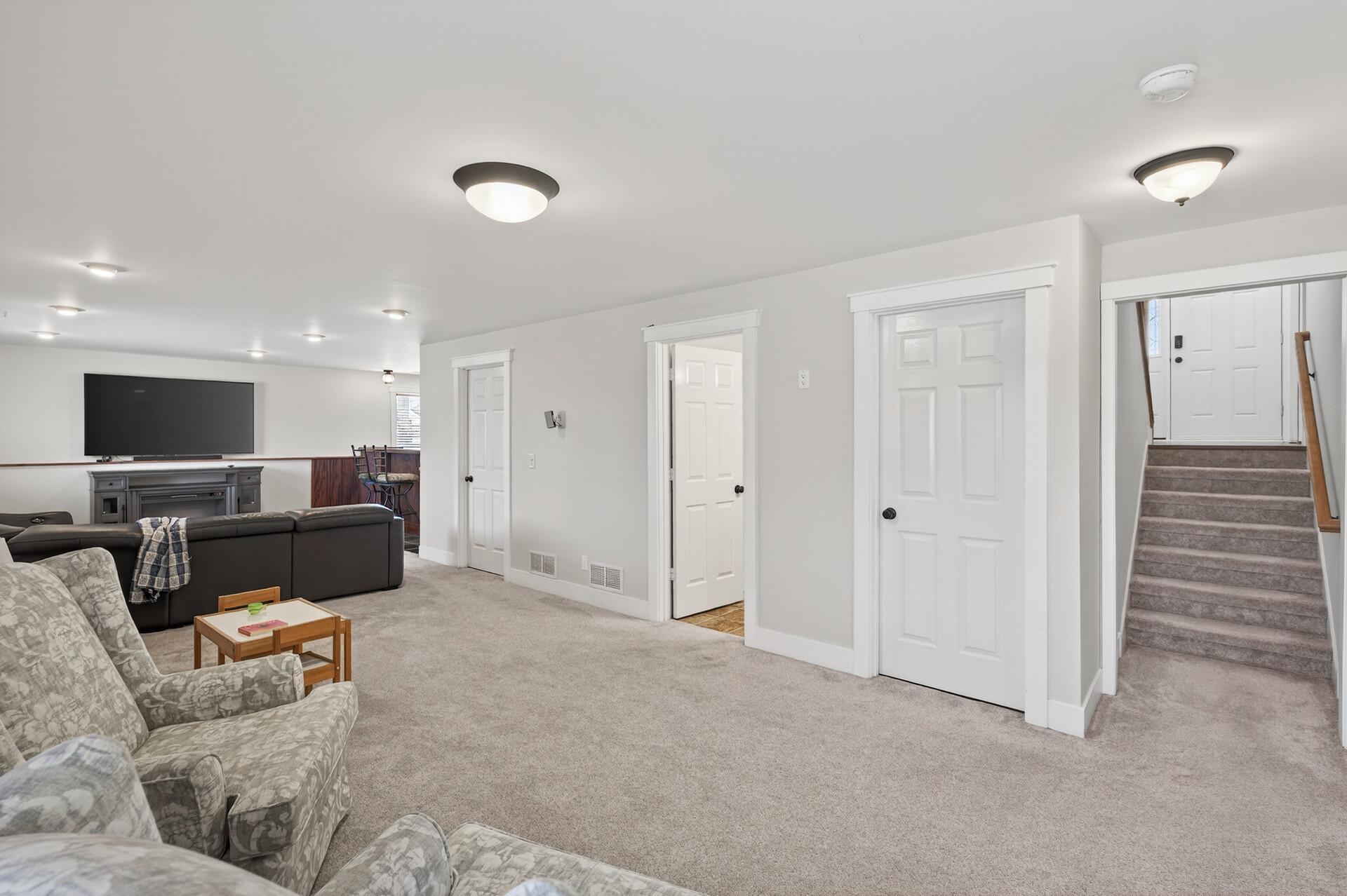 Lower level family room, bar, game area, three quarter tile bath, storage & laundry/mechanical. 2022 carpet.