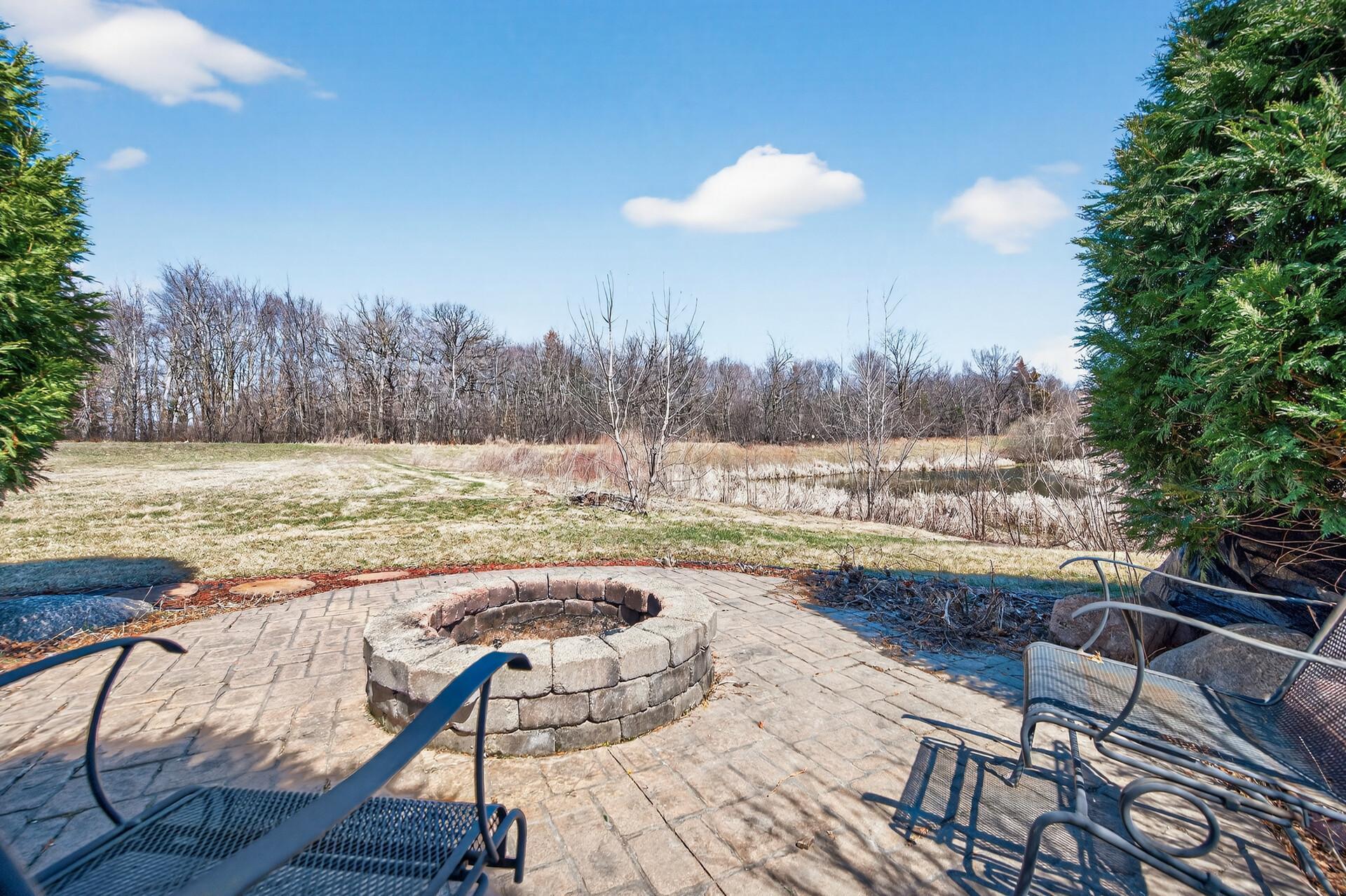 Enjoy the built-in firepit with pond views!