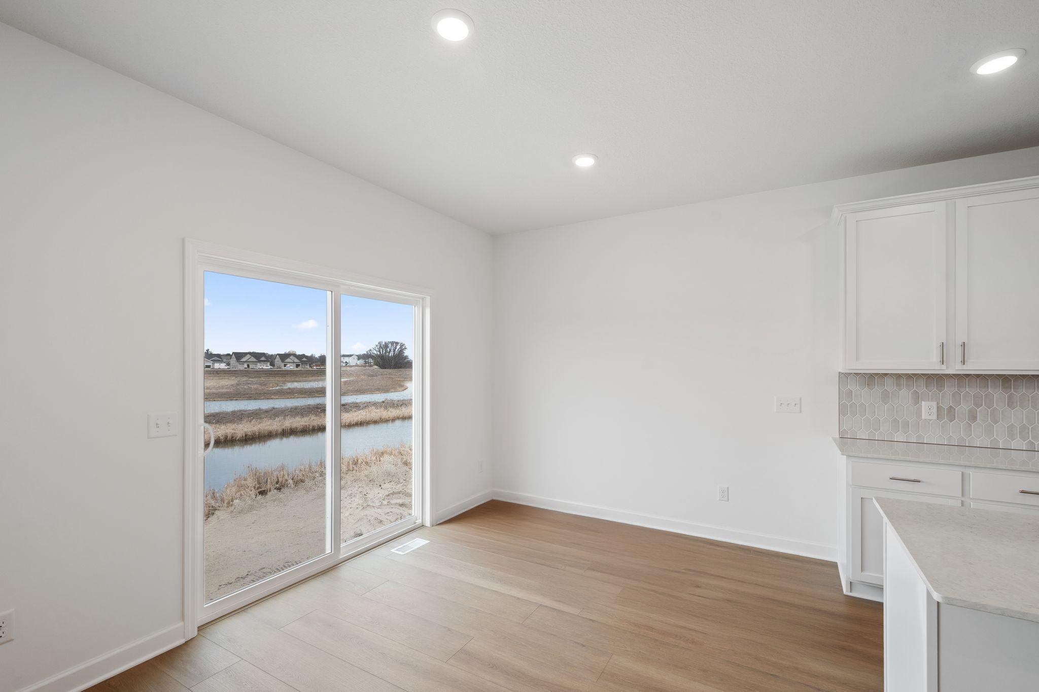 The dining room embraces natural light from a sliding glass door, creating a welcoming space for dinner parties and special occasions.