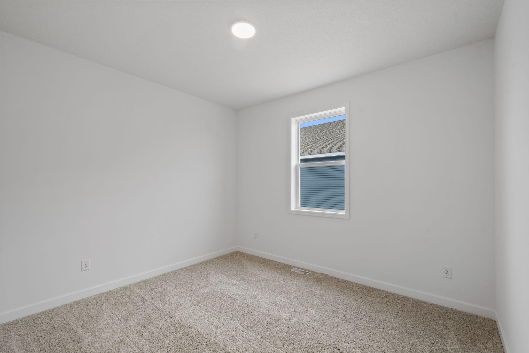 There are two secondary bedrooms down the hall from the owner’s suite.