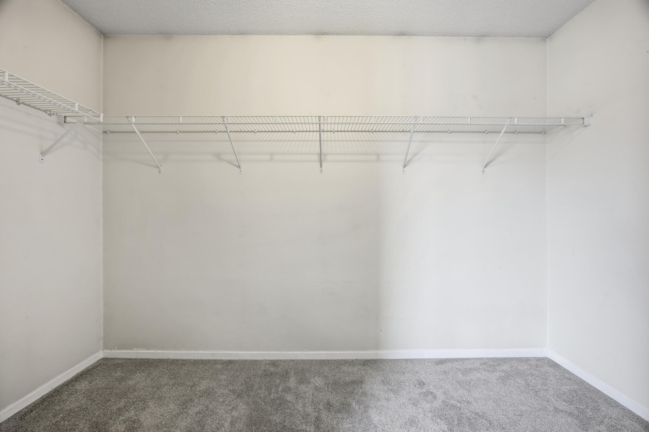 Walk in closet in primary bedroom