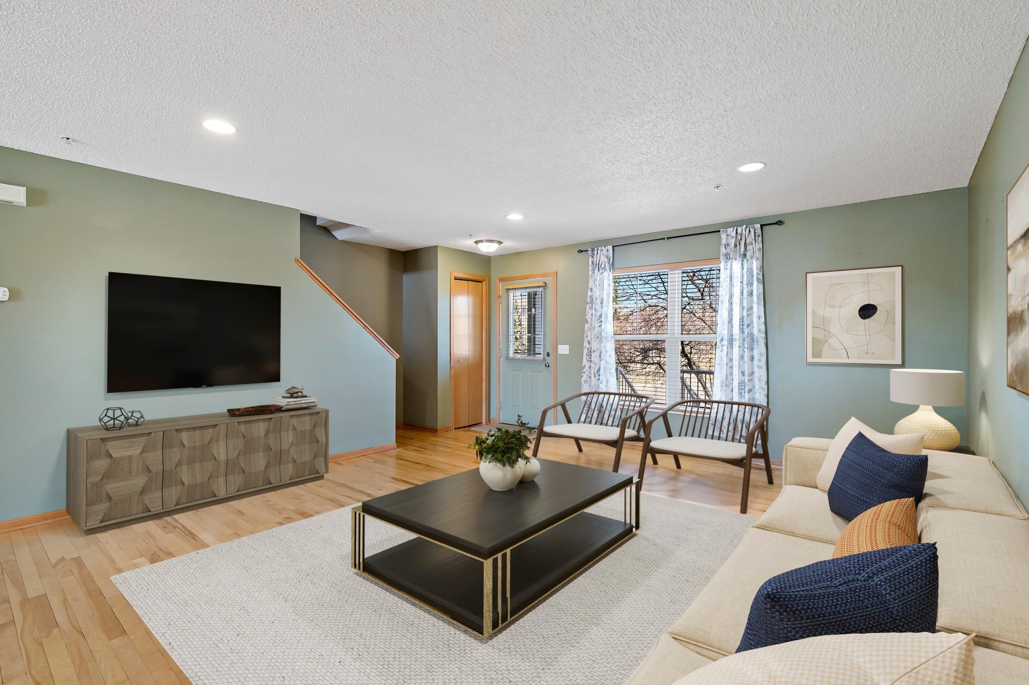 Your new townhouse has windows in the front and back to amplify the natural light, creating an enjoyable, open, warm, and comfortable main level complete with hardwood floors. Virtually staged.