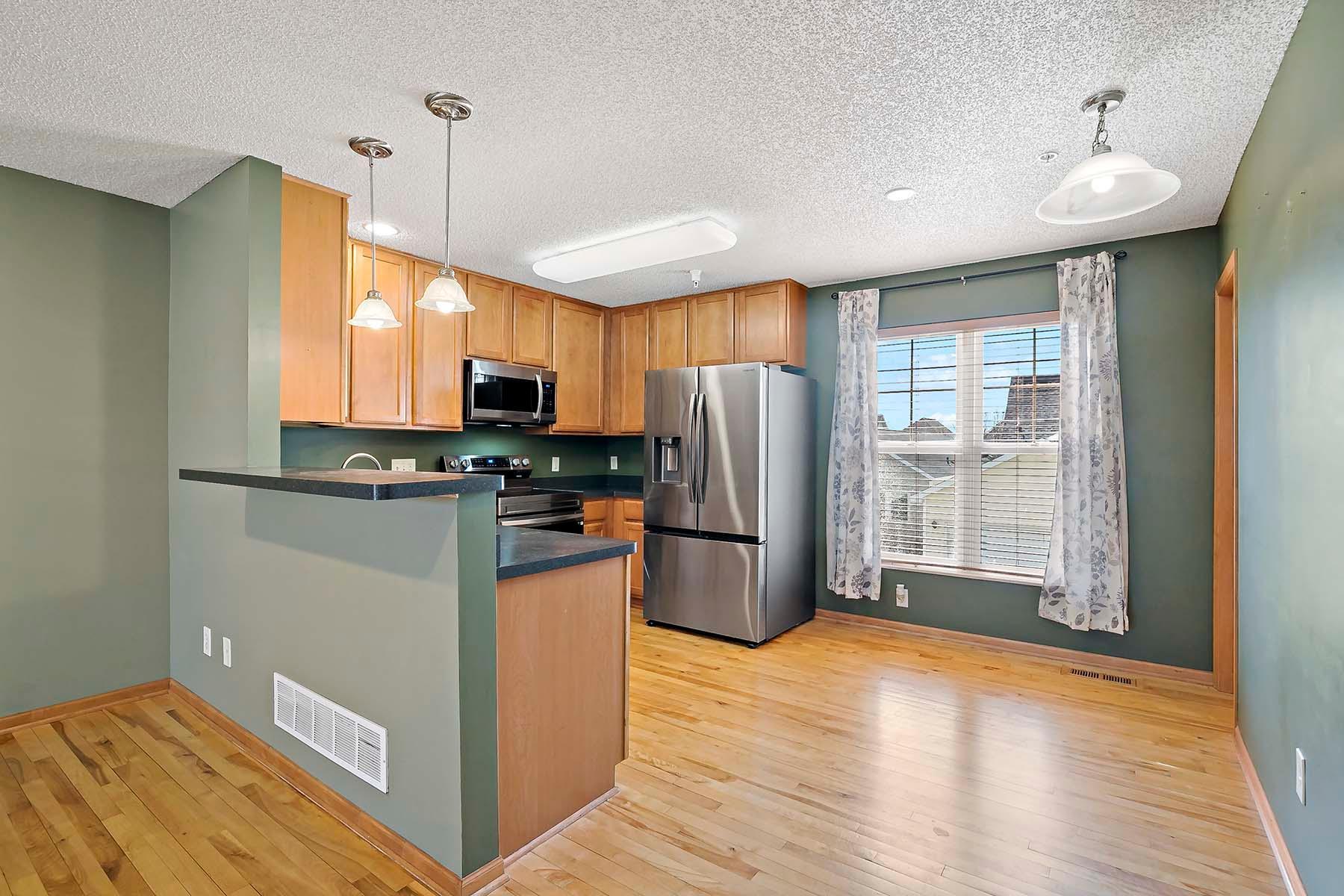 Perfect for movie night! Put the snacks on the breakfast bar so you don't miss a thing! Pantry door to the right for additional storage along with informal dining area.