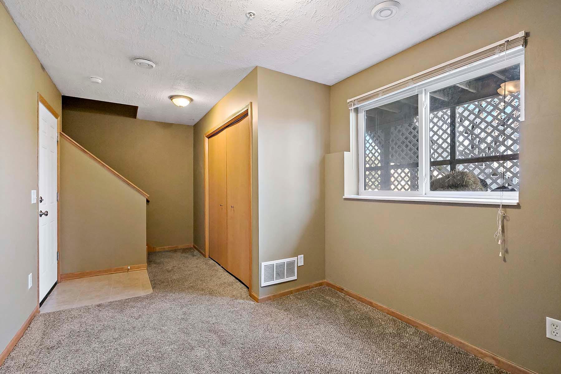 Doorway on left leads to 2-car garage, utility room back center and spacious lower level flex room could be a non-conforming bedroom, office, fitness, crafts or just about any-thing-room.