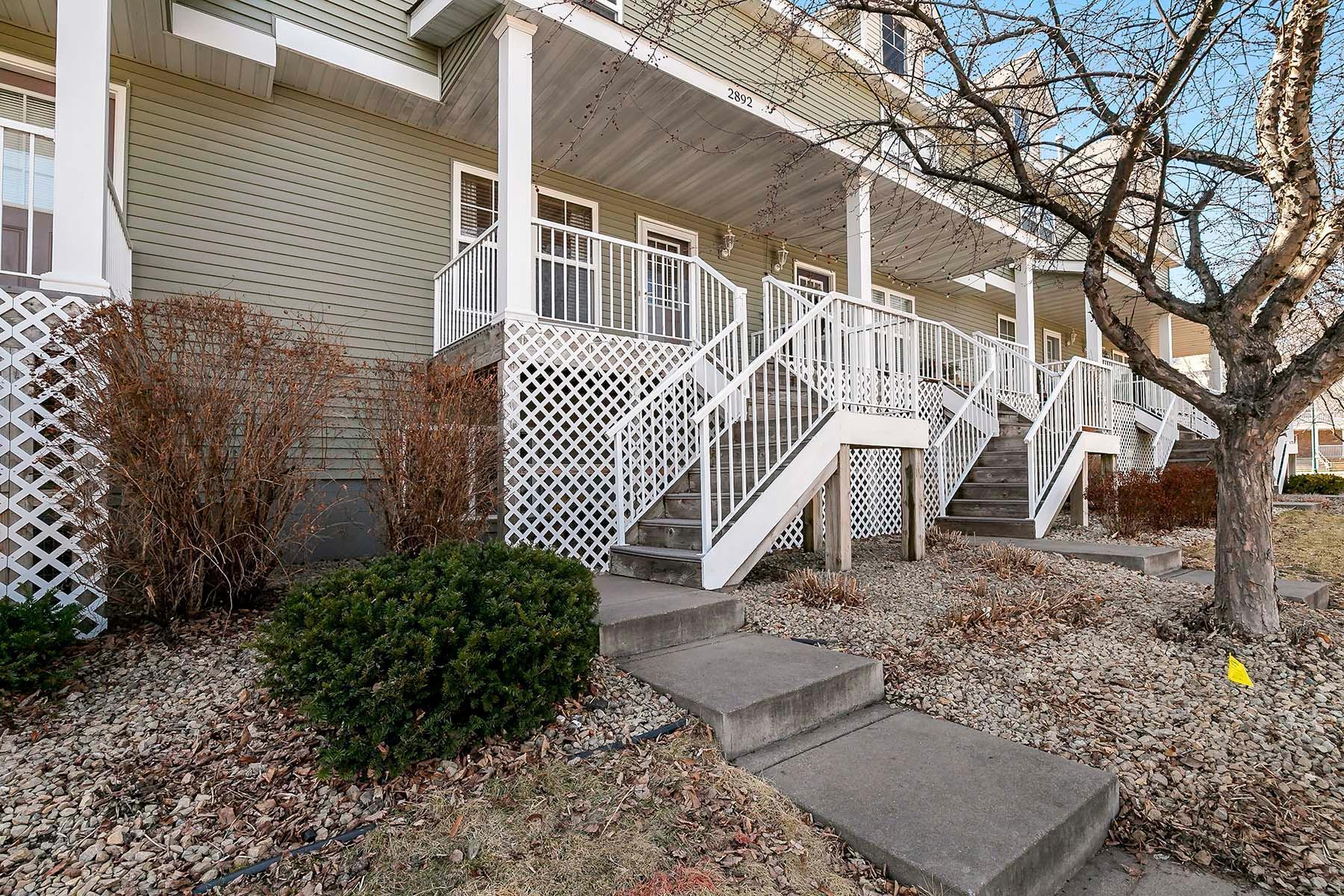 Staircase leading to your townhouse. Association maintained townhouse simplifies your life. Snow, lawn, sanitation, exterior management, water and sewer included in the monthly dues.