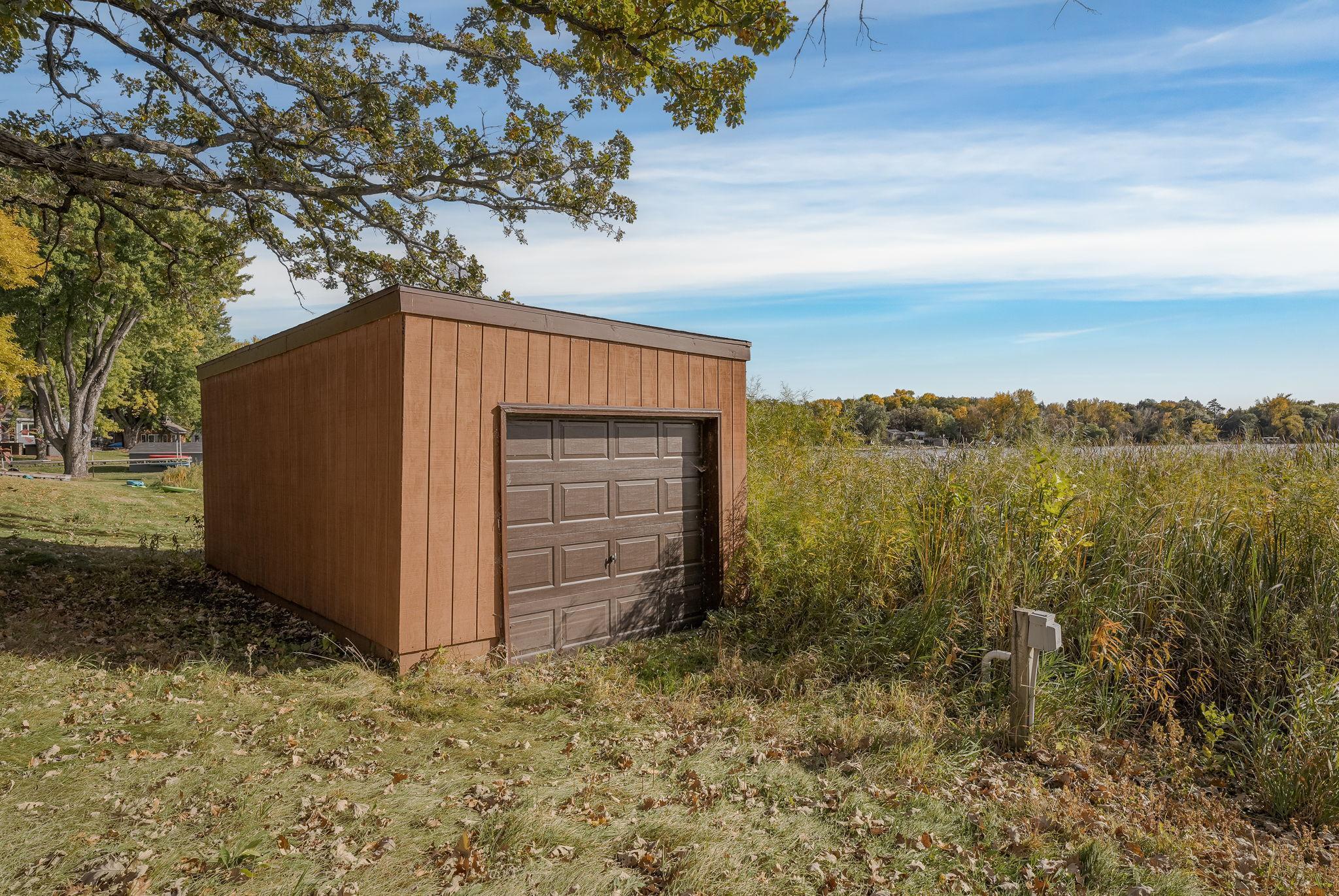 The property also includes a spacious 20' x 12' boat house or detached garage, offering additional storage and versatility for your outdoor gear and equipment.