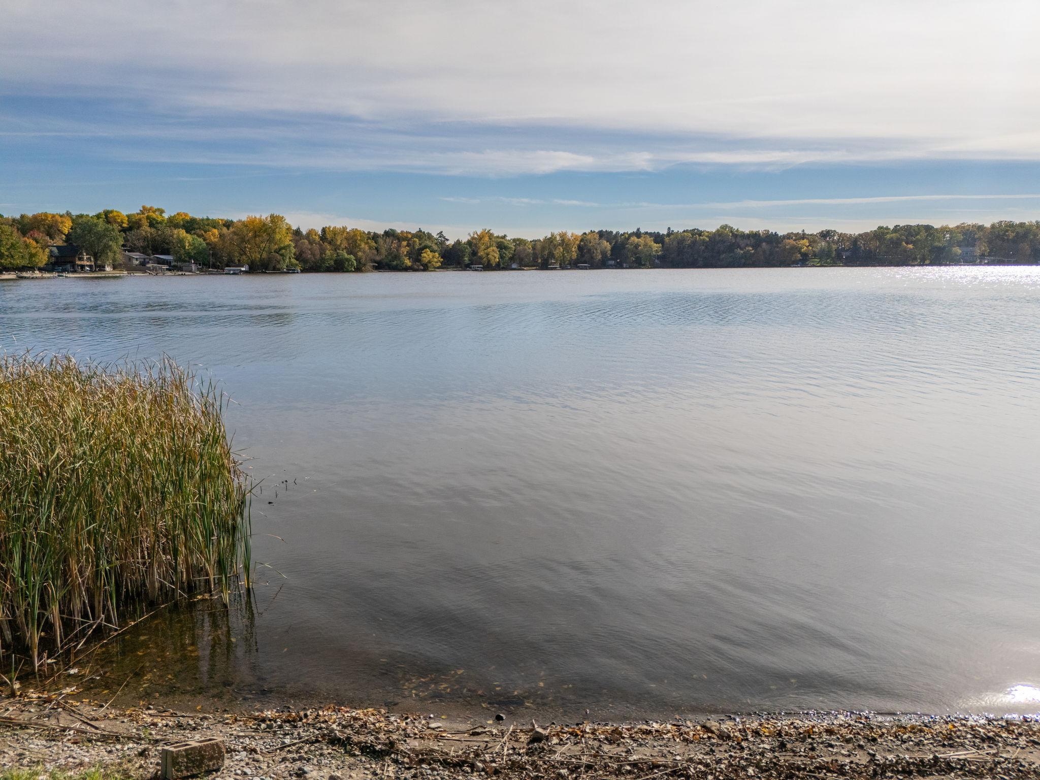 Boasting 201 feet of pristine sandy lakeshore on beautiful Locke Lake.