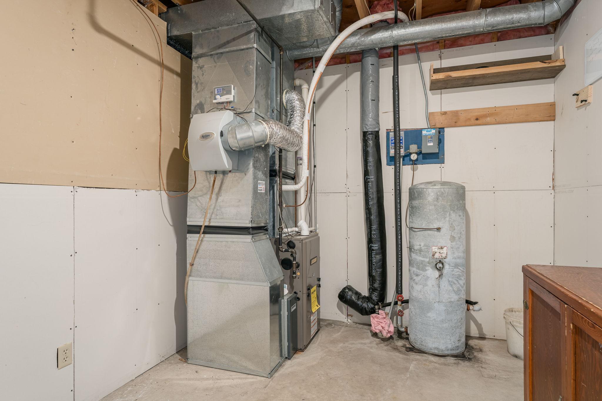 The home is equipped with zoned heating, featuring two newer furnaces and air conditioning unit, ensuring optimal comfort and energy efficiency throughout the house.