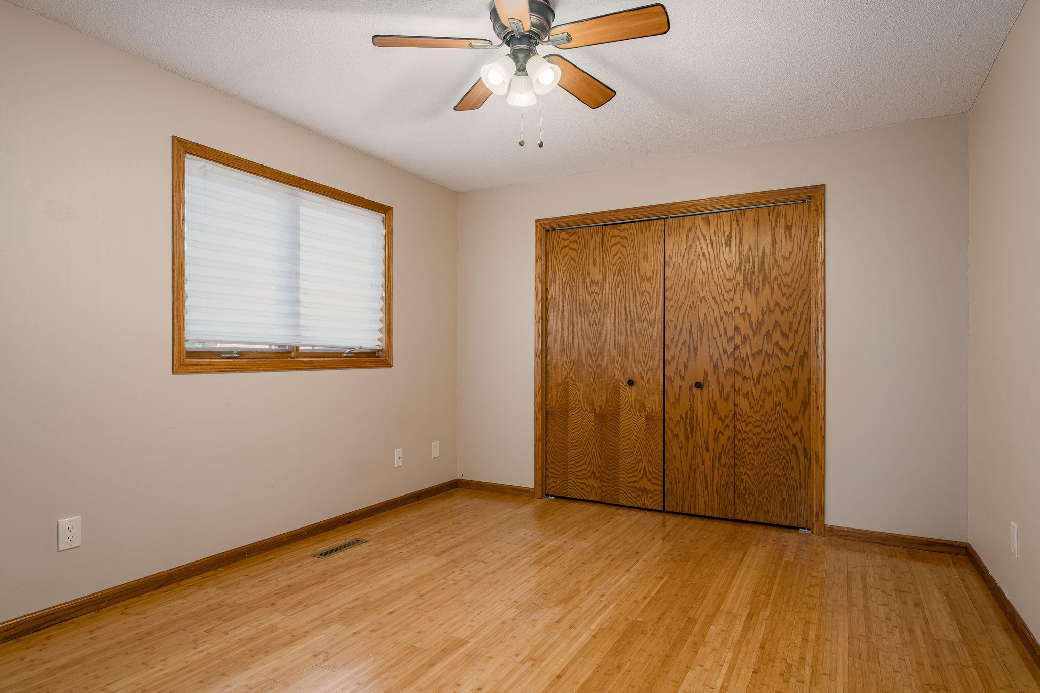 The second bedroom on the main floor also features beautiful bamboo wood floors, adding a cohesive and elegant touch to the space.