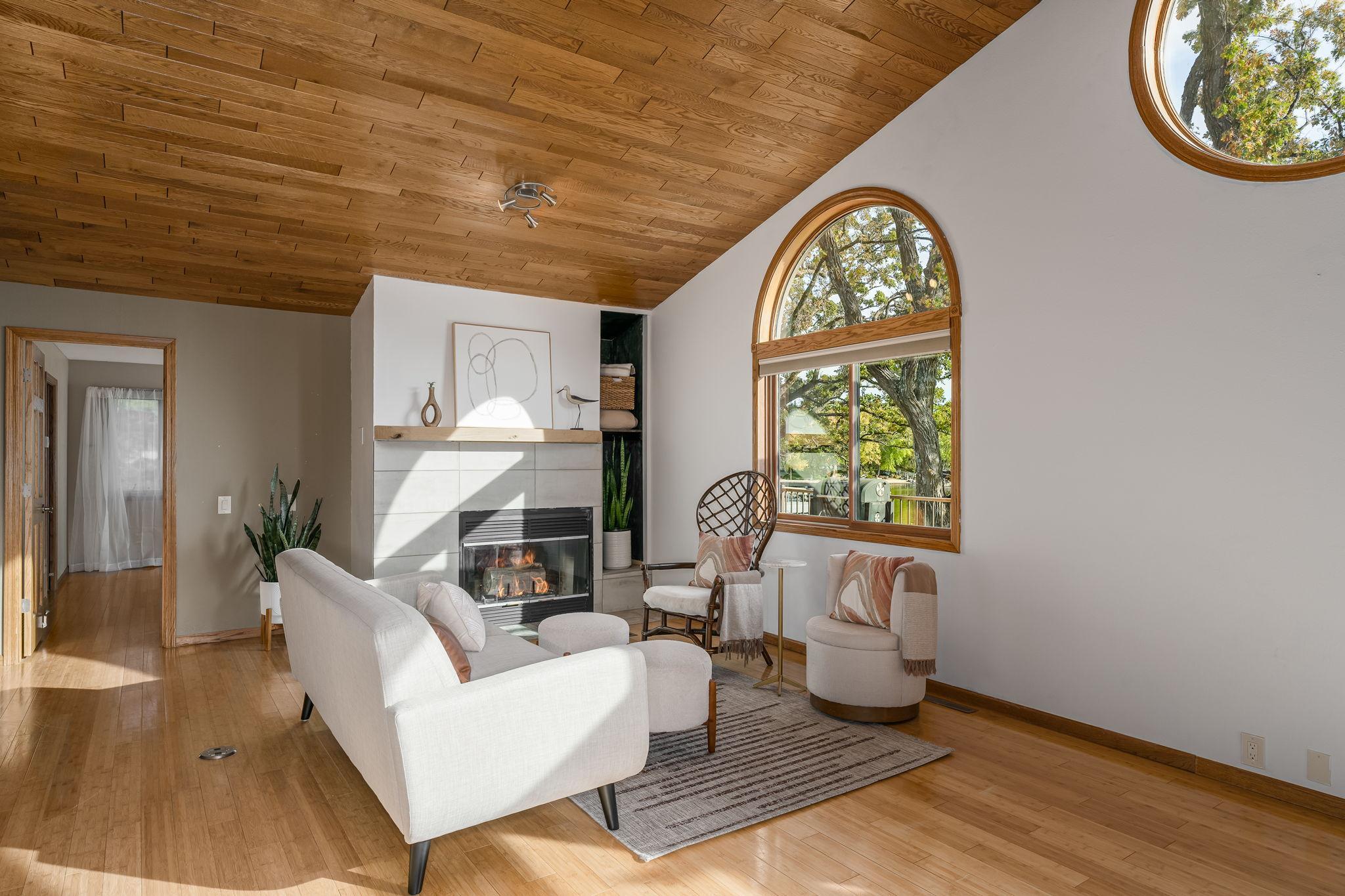 The living room features gas fireplace, elegant bamboo wood floors, adding warmth and charm to the space.