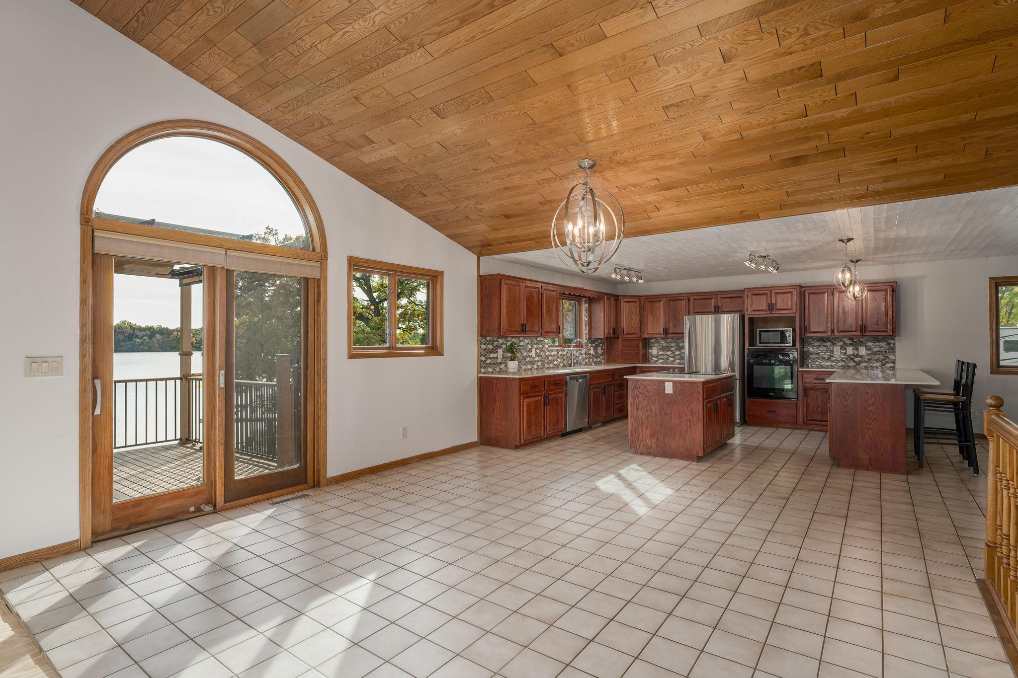 The bright dinette area opens directly onto a full-length deck, providing a perfect transition for indoor-outdoor living and entertaining.