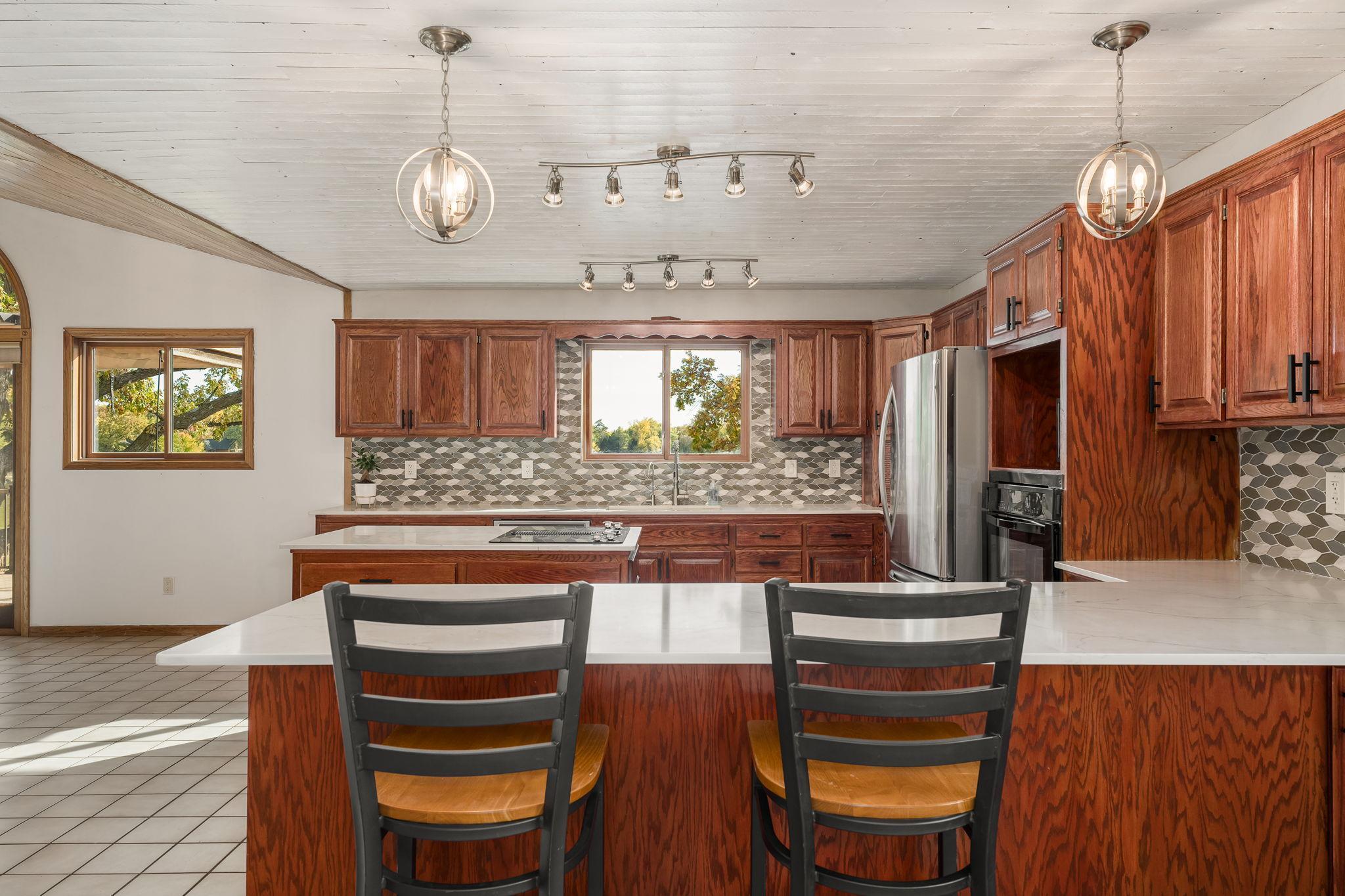 The kitchen is expansive, featuring a large breakfast bar that provides ample space for casual dining and entertaining.