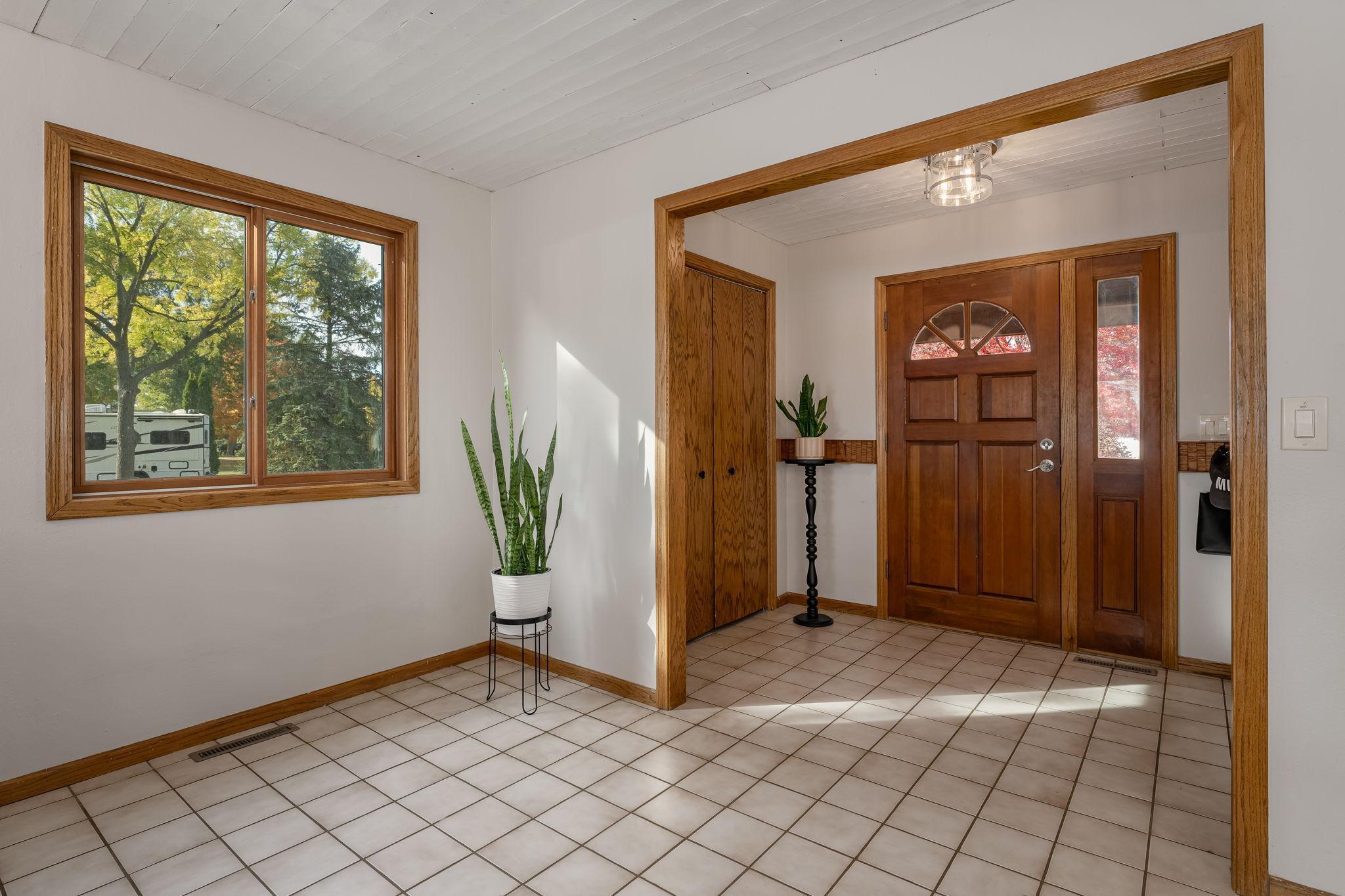 The expansive, inviting foyer, beautifully finished with ceramic tile, sets a warm and welcoming tone as soon as you enter.