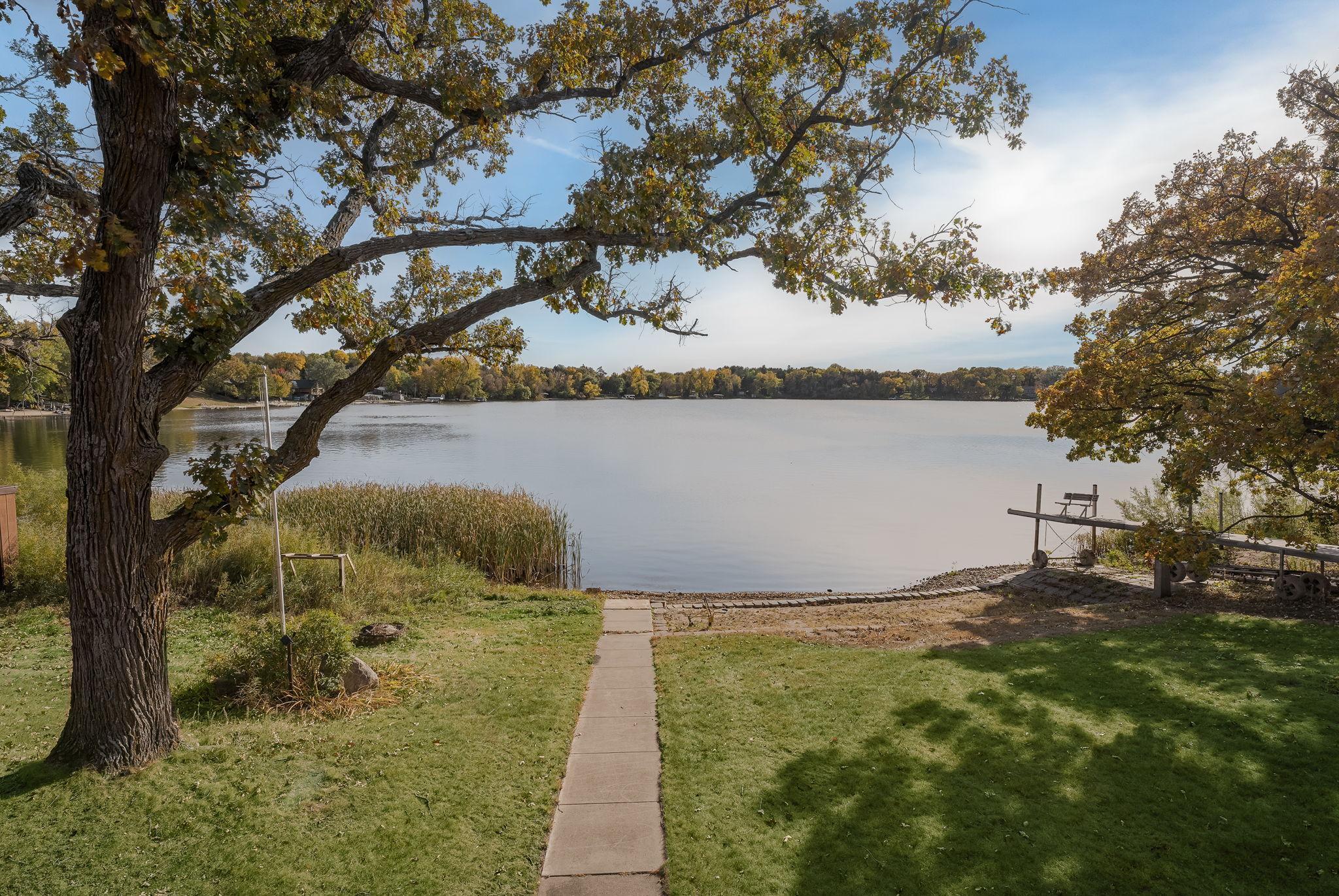 The property features a gentle, gradual slope leading down to the lake, offering easy access and picturesque views.