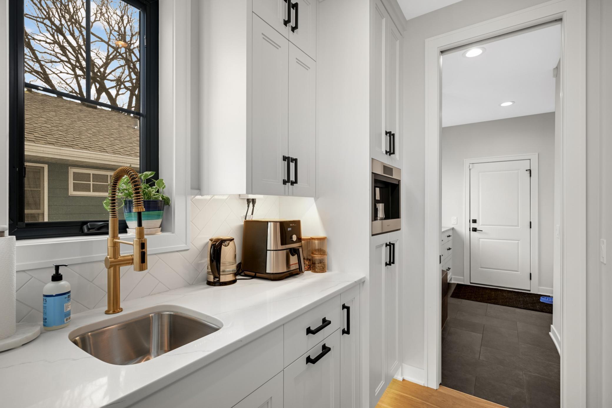 Butler pantry features a Wolf built-in espresso machine