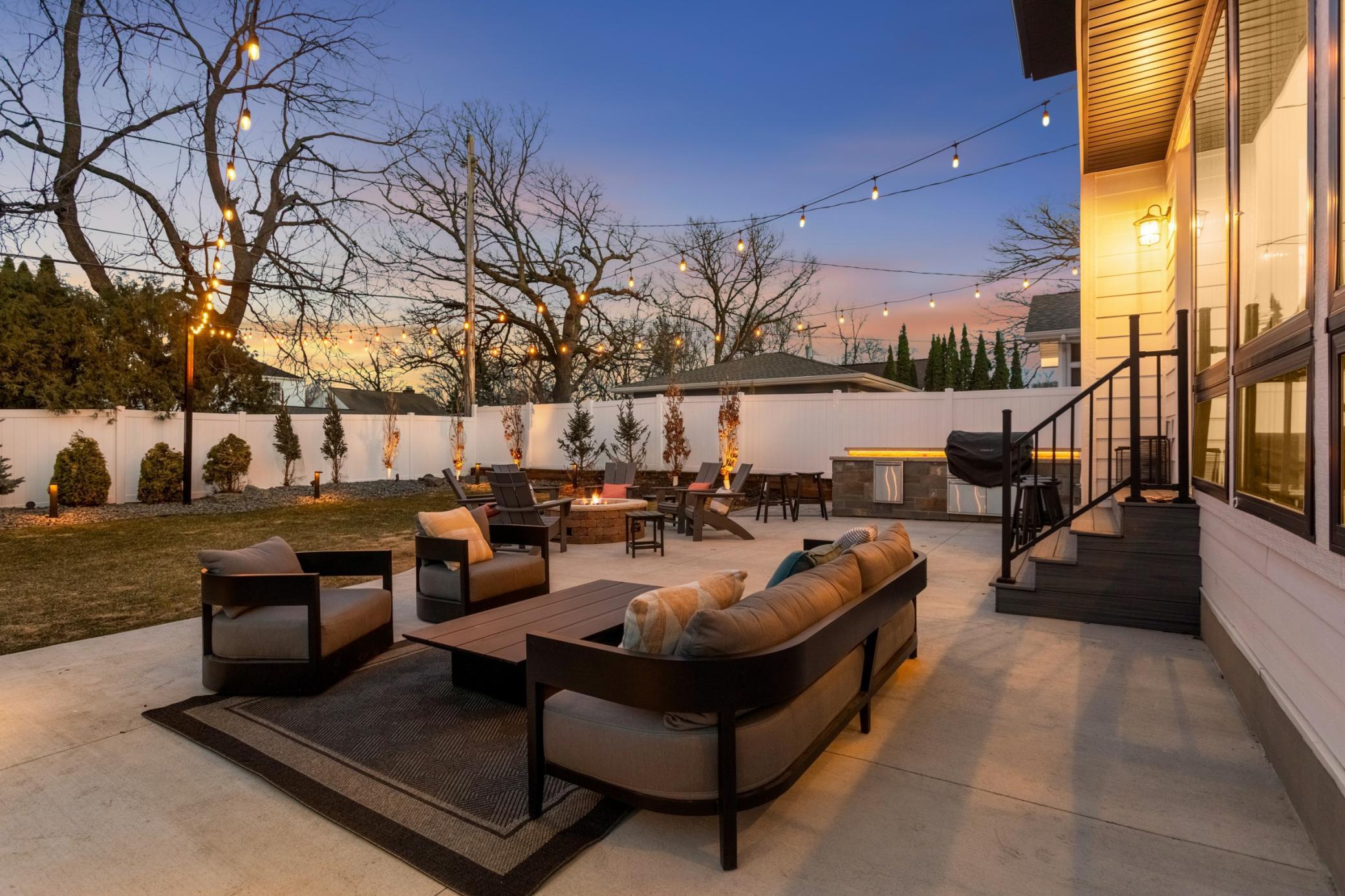 Backyard café with firepit and outdoor kitchen with Wolf built-in grill