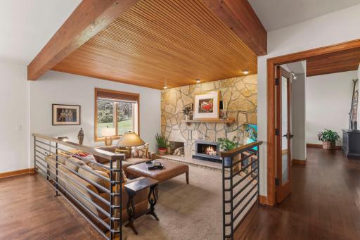 Gorgeous stone fireplace with rich tones and comforting fireplace.