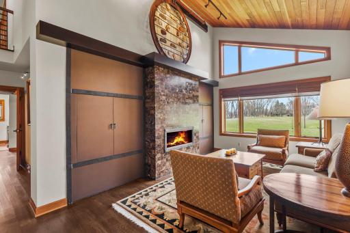 Formal sitting space with custom fireplace and built in's - the right cabinet opens up to reveal the TV on a swivel mount.
