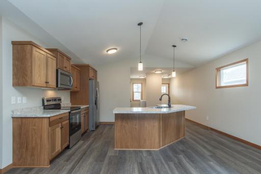 Stunning kitchen featuring a large center island, stainless steel appliances, and abundant cabinetry.