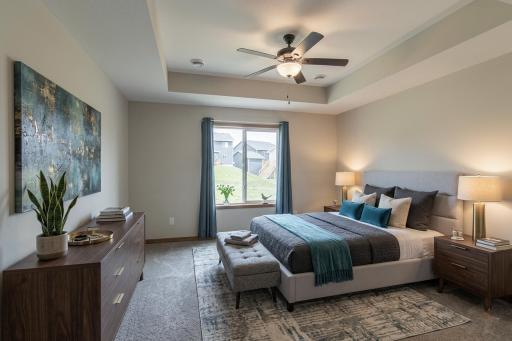 Light-filled primary bedroom with ample space for relaxation.