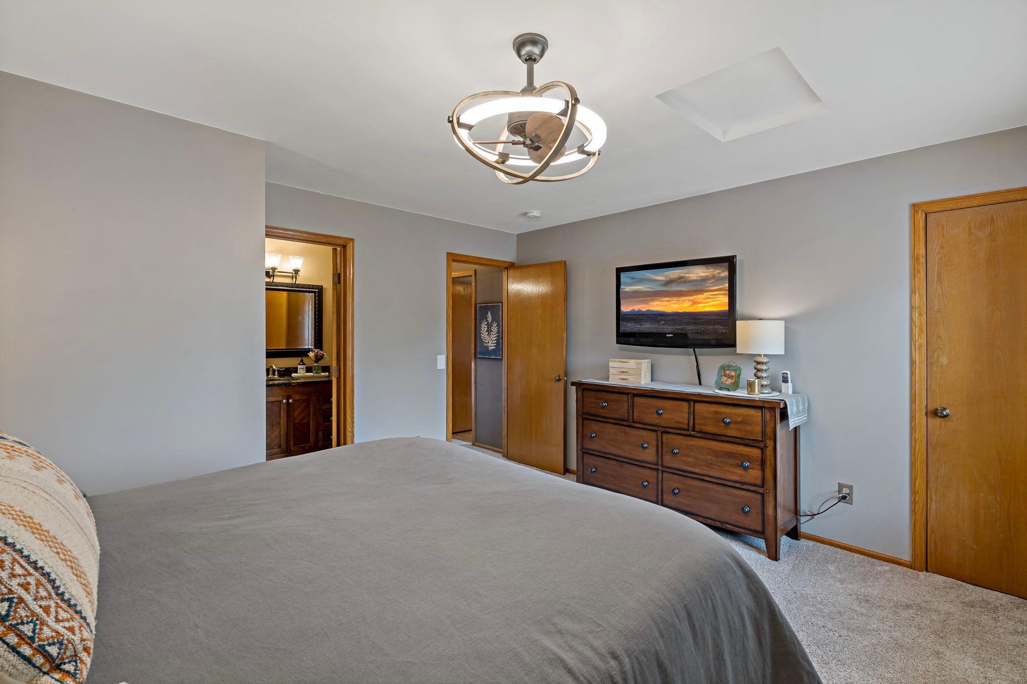 The upper level primary suite has special shelving in the walk in closet.