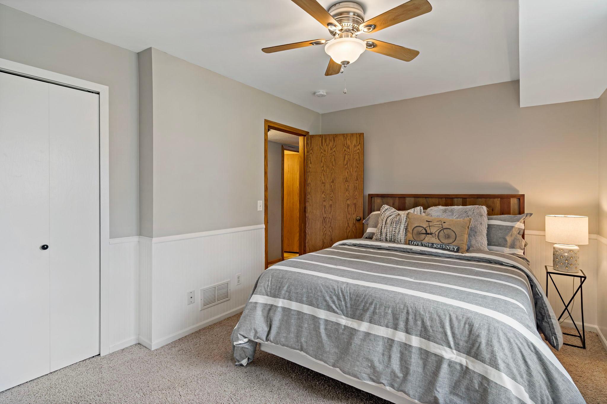 This lower level bedroom is private and inviting.