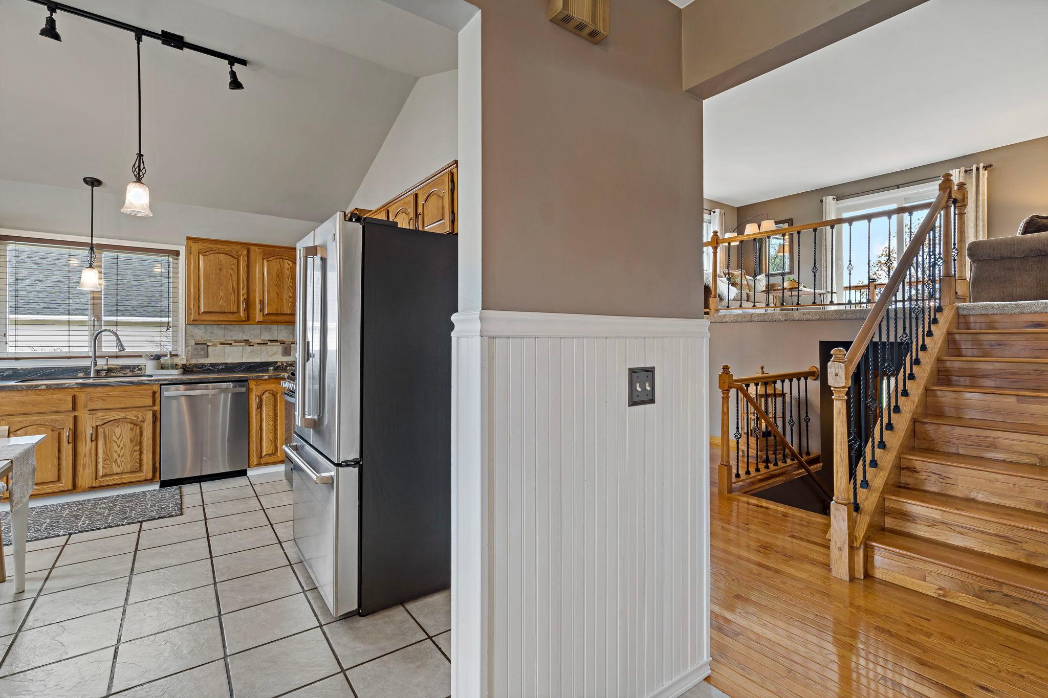 A hardwood stairwell offers a beautiful first impression, while the main-floor kitchen makes unloading groceries a breeze.