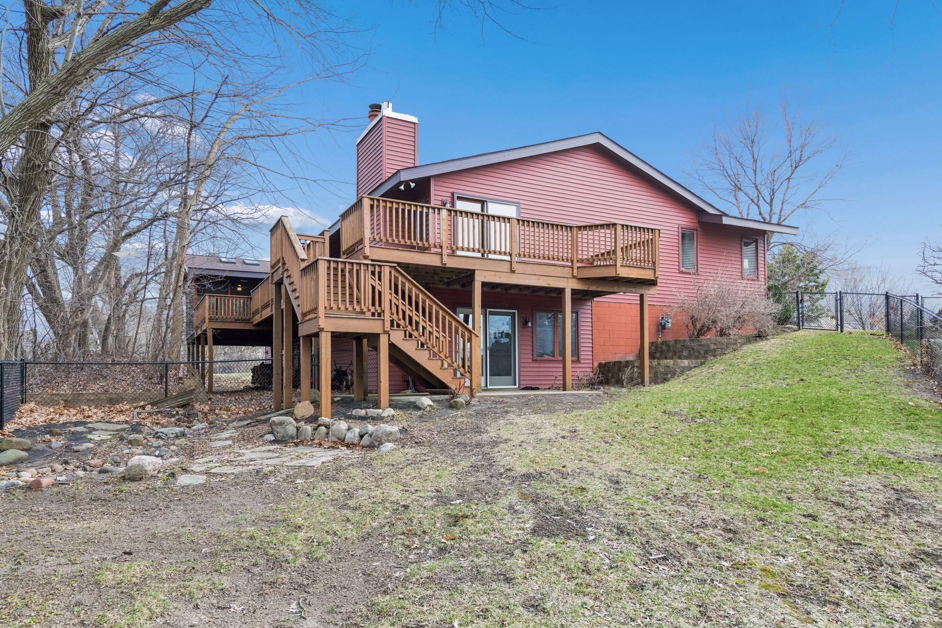 Great view of wrap-around deck and fenced area.