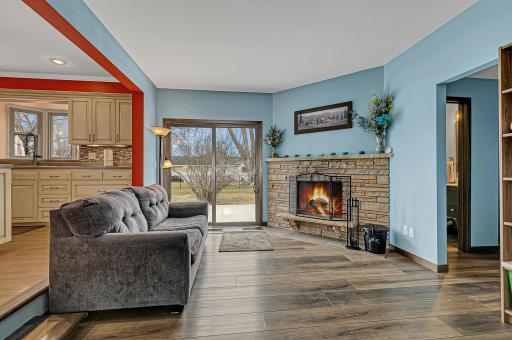 Den area with access to the patio. The den features a wood burning fireplace.