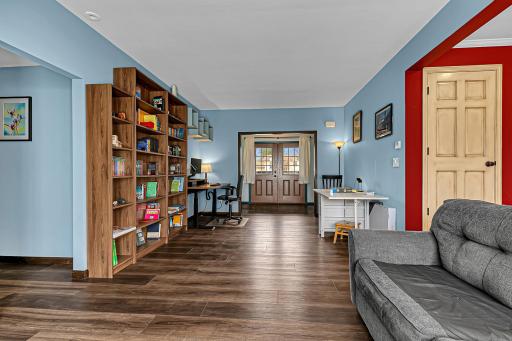 Beautiful flooring with large open faced shelving unit and space for a desk.