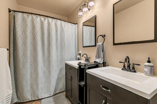 The private bath has been remodeled offers ceramic tile flooring, and dual sinks.