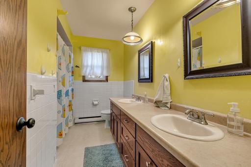 A second full bathroom with a double sink vanity serves the additional bedrooms, plus there is a large hallway linen closet that provides more storage space.