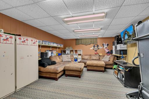 Lower level family room with tons of space for the kids to play in.
