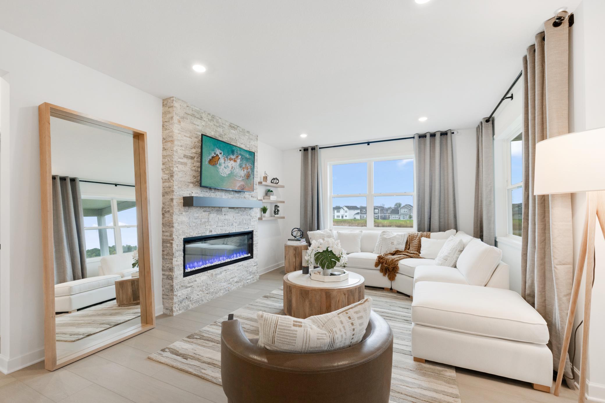 (Photo of a similar home, actual home's finishes will vary slightly) The spacious great room.